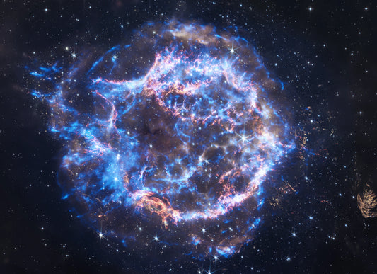 Expanding supernova remnant in space with bright blue and orange colors against a dark background.